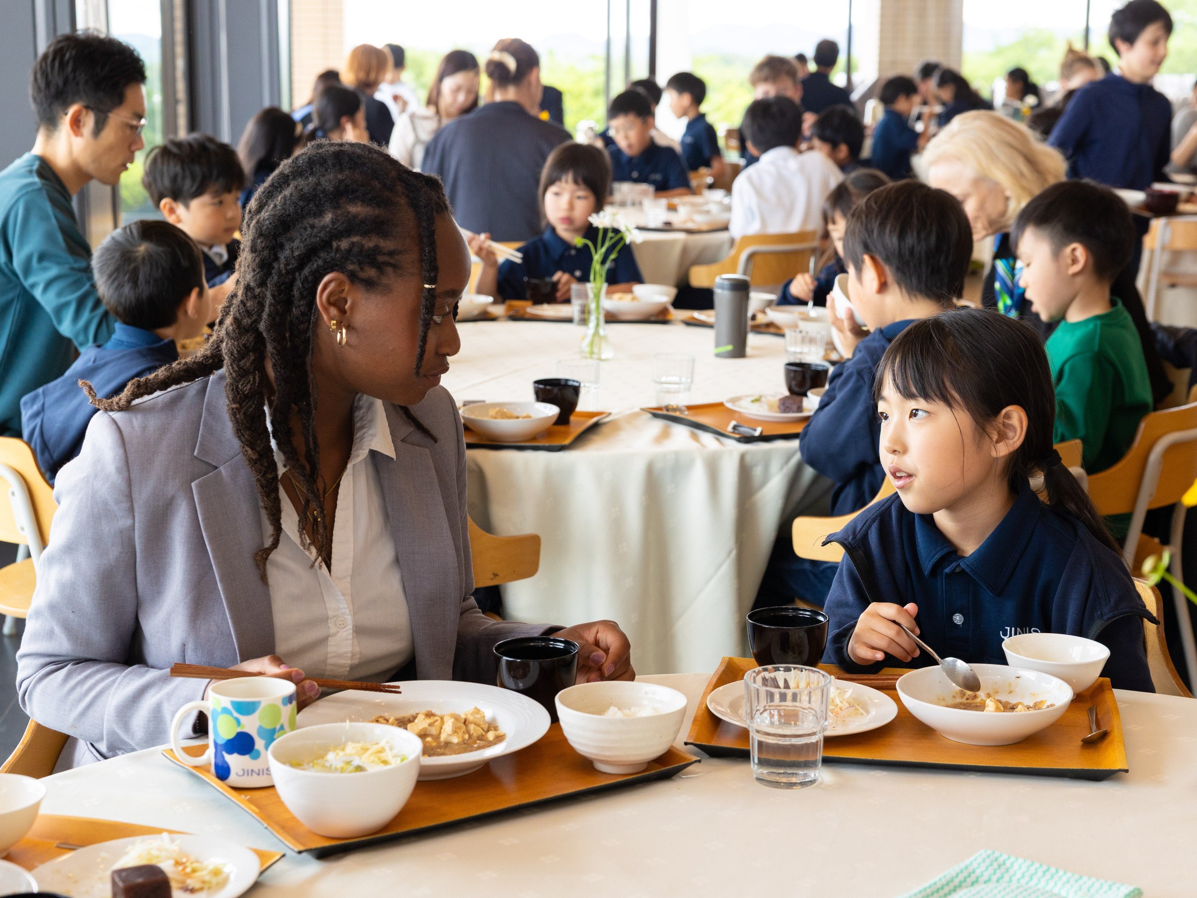 Lunch in the dining hall, pupils and staff at the same tables