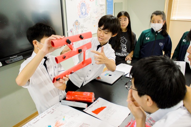 Boys at Kumamoto International School presenting their work to their classmates